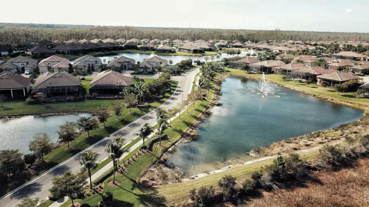 Aerial view of tile-roofed houses and waterways in Fort Myers, Florida